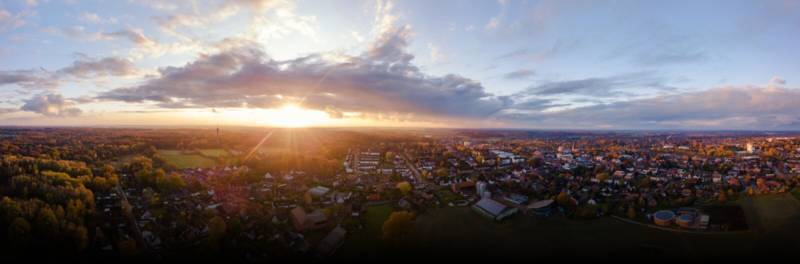 A town and the countryside around it, seen from above at sunset
